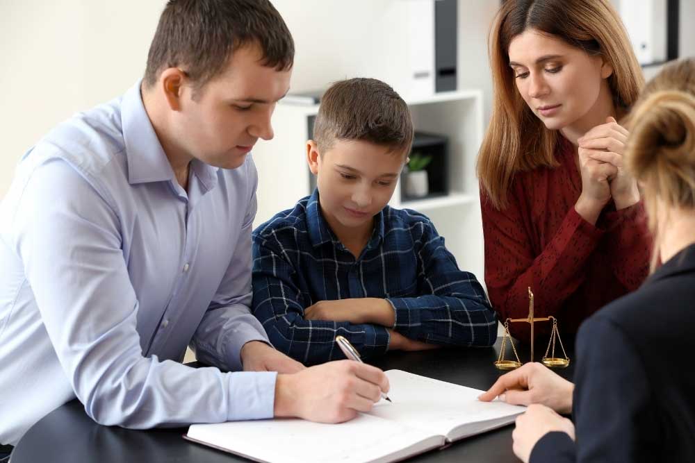Indiana-Child-Support-Guidelines-2026–What-Hamilton-County-Parents-Need-to-Know-2 Parents with child meeting attorney in office discussing Indiana child support and custody arrangements.