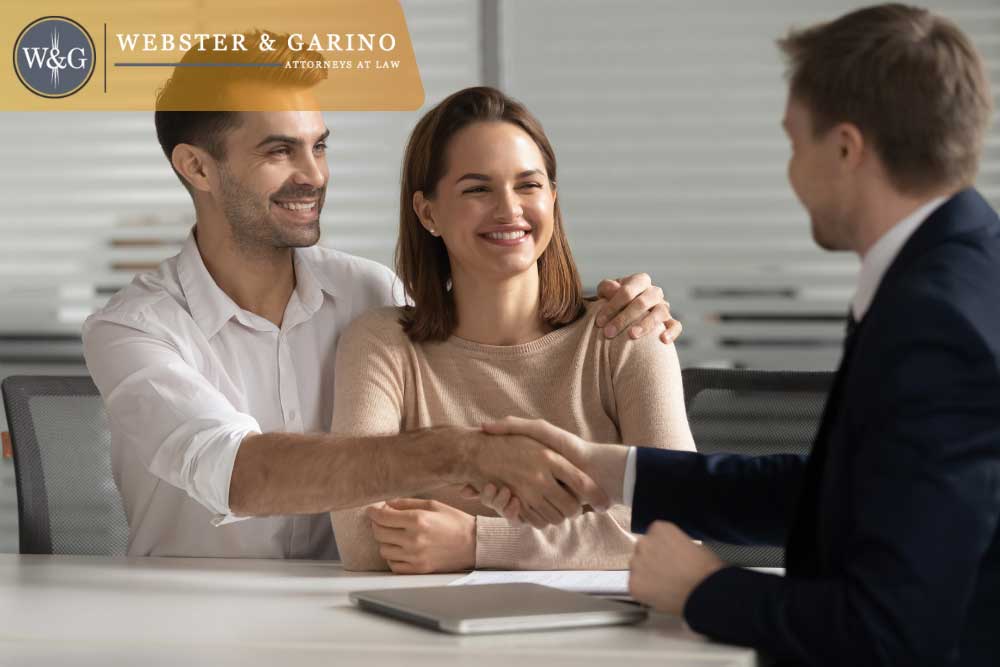 Happy clients shaking hands with Webster & Garino estate planning lawyer in Indiana