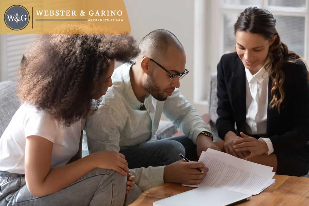 Couple signing estate planning documents with Webster & Garino attorney in Indiana