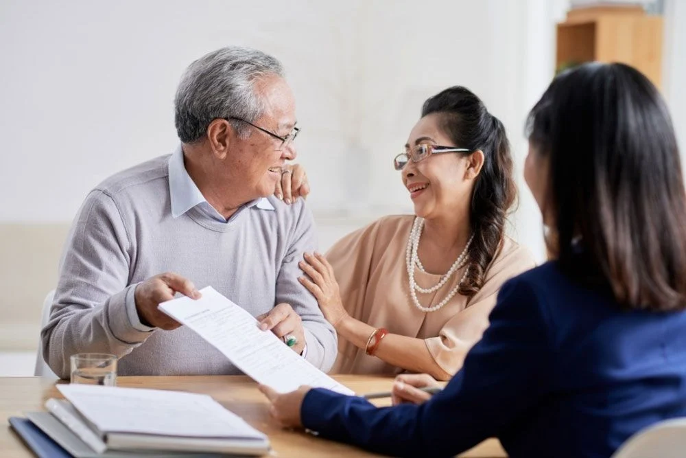 Elderly couple smiling during estate planning consultation with Webster & Garino attorney in Indiana.
