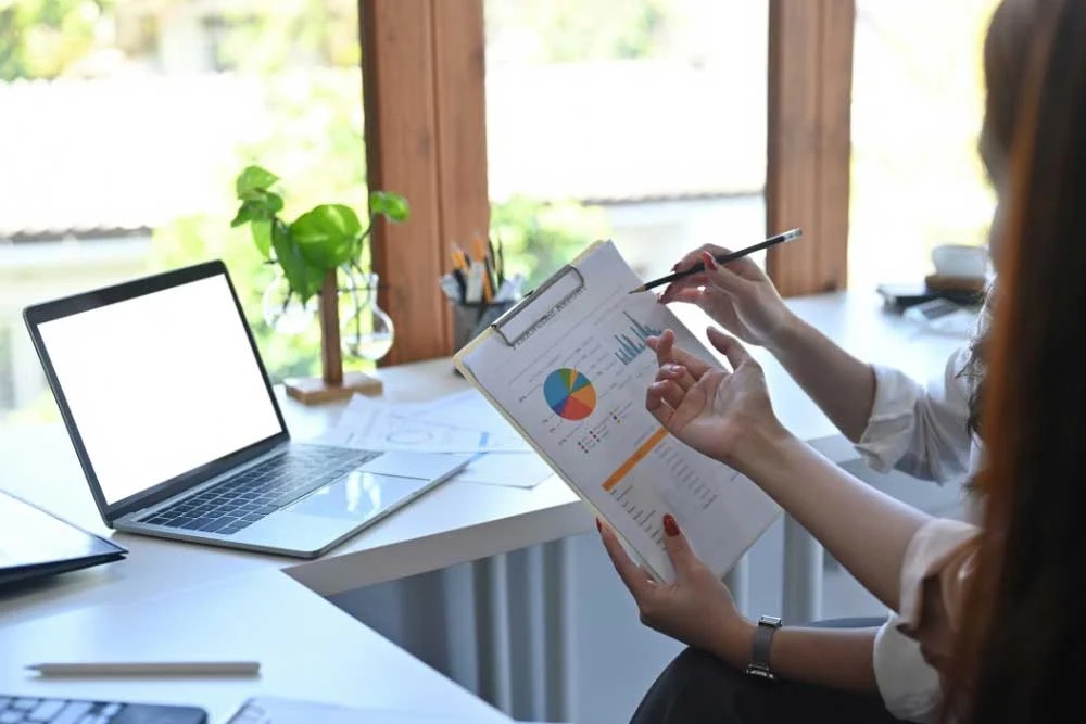 Webster Legal attorney reviews charts with client during Indiana case strategy meeting