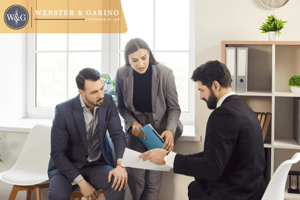 Indiana probate attorney meeting with clients to review creditor claims and deadlines, guided by Webster & Garino