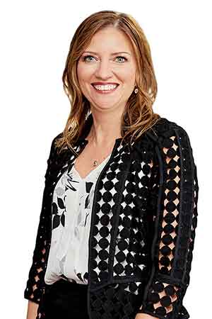 A smiling woman in a black and white outfit represents a trusted Indiana law firm offering compassionate legal guidance.| Webster & Garino, LLC | Indiana Law Firm serving Hamilton County